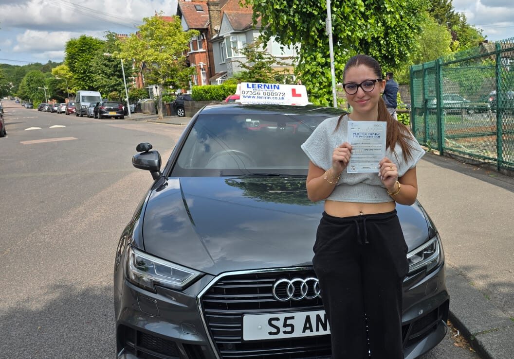 First-time pass after driving lessons Chingford Test Centre with Layla, holding their driving test pass certificate
