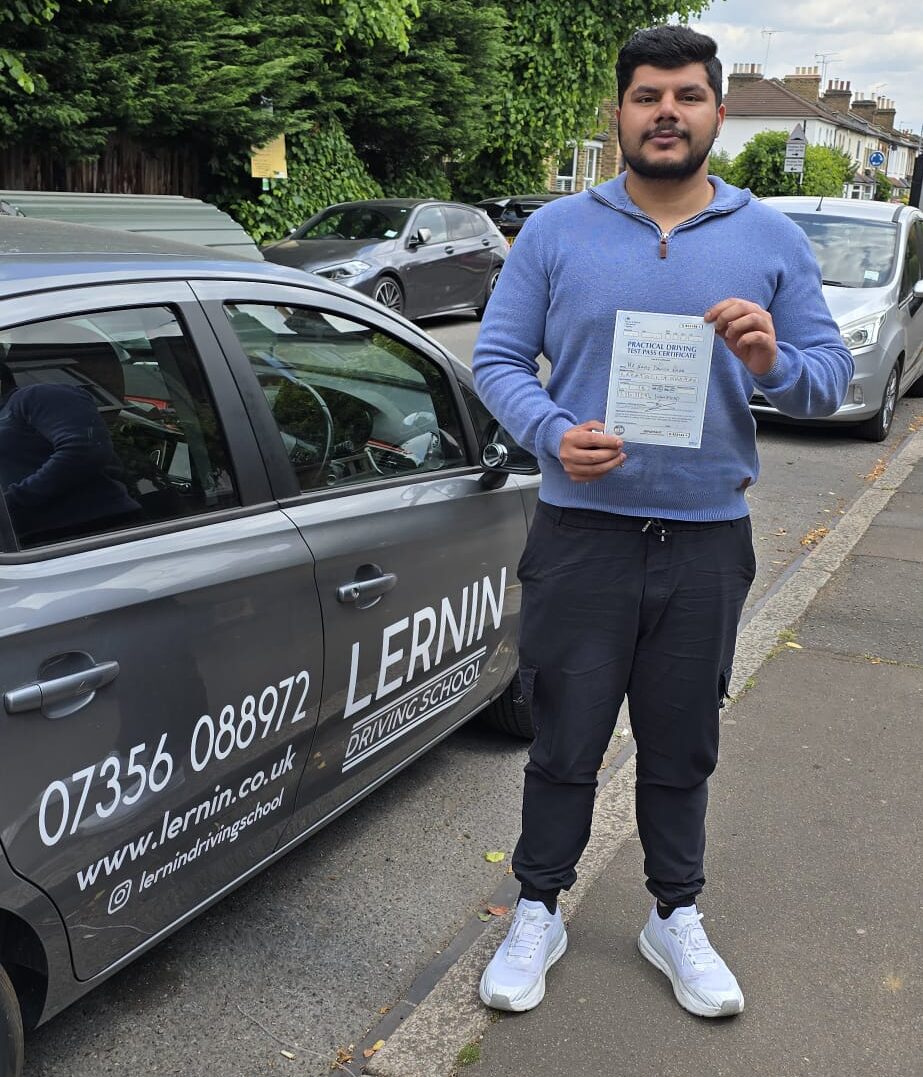 First-time pass at Wanstead Test Centre with Danish, holding their driving test pass certificate. driving lessons chingford