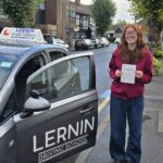 Learner driver celebrating test pass after driving lessons in Chingford