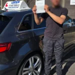 Student celebrating success after driving lessons in Loughton